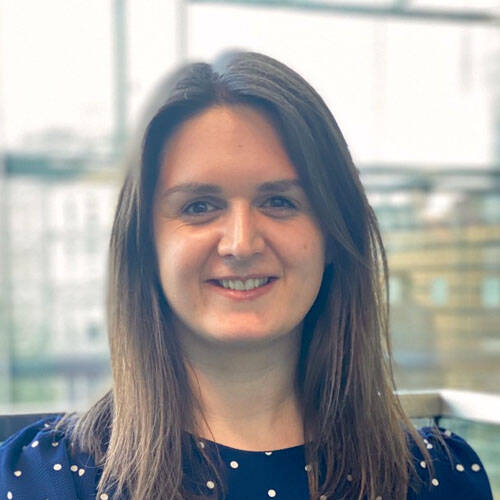 Smiling woman in an office setting.